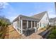 Exterior view of a screened porch with ceiling fan and patio at 1929 Finnish Ln, Kennesaw, GA 30152