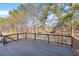 A cozy wooden deck provides views of the peaceful lake beyond the treeline at 2517 Hampton Park Ct, Marietta, GA 30062