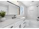Bright bathroom with a white vanity, black fixtures, tub, and a large framed mirror at 2517 Hampton Park Ct, Marietta, GA 30062