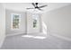 Sunny bedroom with neutral carpet, a ceiling fan, and two windows for ample natural light at 2517 Hampton Park Ct, Marietta, GA 30062