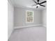 Cozy bedroom with neutral carpet, a ceiling fan, and a window providing natural light at 2517 Hampton Park Ct, Marietta, GA 30062