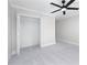 Bedroom with neutral carpet, a ceiling fan, and a closet with open doors at 2517 Hampton Park Ct, Marietta, GA 30062
