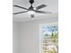 Bright bedroom featuring neutral paint, ceiling fan, and a large window overlooking a treed backyard at 2517 Hampton Park Ct, Marietta, GA 30062