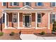 Close-up of an inviting front porch featuring brickwork, white columns, and manicured landscaping at 2517 Hampton Park Ct, Marietta, GA 30062