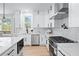 Bright white kitchen featuring stainless steel appliances, marble countertops, and hexagon tile backsplash at 2517 Hampton Park Ct, Marietta, GA 30062