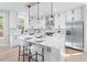 Open kitchen features white cabinets, stainless steel appliances, and marble countertops at 2517 Hampton Park Ct, Marietta, GA 30062