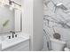 Modern powder room features marble accent wall and floating vanity with matte black fixtures at 2517 Hampton Park Ct, Marietta, GA 30062