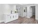 Modern wet bar featuring hardwood floors, white cabinetry, and stone countertops at 2517 Hampton Park Ct, Marietta, GA 30062