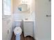 Cozy bathroom featuring a toilet, vanity, mirror, and white tiled shower with modern fixtures at 2628 Miriam Ln, Decatur, GA 30032