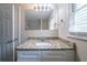 Bathroom vanity with granite counters, white cabinet, and modern lighting at 2628 Miriam Ln, Decatur, GA 30032