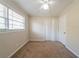 Bedroom with ceiling fan, carpet flooring, and a window with blinds at 2628 Miriam Ln, Decatur, GA 30032