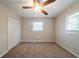 Cozy bedroom with neutral colors, carpeted flooring, and a ceiling fan at 2628 Miriam Ln, Decatur, GA 30032