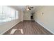 Inviting living room featuring large windows and wood look laminate flooring at 2628 Miriam Ln, Decatur, GA 30032