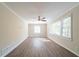 Spacious living room featuring large windows and wood look laminate flooring at 2628 Miriam Ln, Decatur, GA 30032