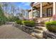 Beautifully landscaped backyard with tiered stone retaining walls, manicured hedges, and steps leading to a covered porch at 2814 Adams Oaks Ln, Marietta, GA 30062