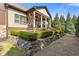 Landscaped backyard with manicured hedges and an outdoor seating area on a covered porch at 2814 Adams Oaks Ln, Marietta, GA 30062