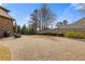 Well-maintained backyard featuring a spacious paved area, lush lawn, and mature landscaping at 2814 Adams Oaks Ln, Marietta, GA 30062