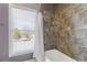 Bathroom featuring a tiled shower and a view of the exterior at 2814 Adams Oaks Ln, Marietta, GA 30062