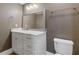 Stylish bathroom featuring a white vanity with granite countertop, modern lighting, and a framed mirror at 2814 Adams Oaks Ln, Marietta, GA 30062