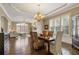 Elegant dining room with hardwood floors, a chandelier, and ample natural light at 2814 Adams Oaks Ln, Marietta, GA 30062