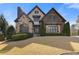 Beautiful two-story home with a combination of stone and brickwork, plus a well-manicured lawn at 2814 Adams Oaks Ln, Marietta, GA 30062