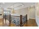 Second story view of foyer with hardwood floors, iron railing and elegant chandelier at 2814 Adams Oaks Ln, Marietta, GA 30062