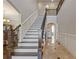 Grand foyer featuring a staircase with dark wood accents and elegant tile flooring at 2814 Adams Oaks Ln, Marietta, GA 30062