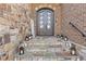 Inviting front entrance with stone steps, decorative lanterns, and an elegant wrought iron front door at 2814 Adams Oaks Ln, Marietta, GA 30062