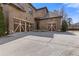 View of the three-car garage with decorative doors and a spacious driveway at 2814 Adams Oaks Ln, Marietta, GA 30062
