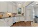 Bright kitchen with white cabinetry, black granite countertops, and stainless steel appliances at 2814 Adams Oaks Ln, Marietta, GA 30062