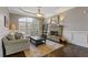 Cozy living room with a stone fireplace, large windows, and stylish furniture at 2814 Adams Oaks Ln, Marietta, GA 30062