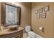Stylish powder room has vessel sink, granite countertop, custom cabinetry and framed artwork at 2814 Adams Oaks Ln, Marietta, GA 30062