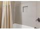 Modern bathroom shower with sleek tile work, a built-in niche, and a contrasting dark faucet at 2814 Adams Oaks Ln, Marietta, GA 30062