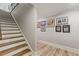 Stairway leading to the basement, featuring new wooden floors and framed prints on the wall at 2814 Adams Oaks Ln, Marietta, GA 30062