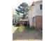 Back exterior view of the home showing a brick wall and outdoor area at 3274 Jodeco Pl, Jonesboro, GA 30236