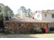Back exterior view of the home showing a stone wall at 3274 Jodeco Pl, Jonesboro, GA 30236