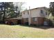 View of the spacious backyard featuring a mix of brick and vinyl siding with a chimney at 3274 Jodeco Pl, Jonesboro, GA 30236