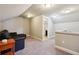Open attic space with leather sofa, carpeted floors, and a full bathroom nearby at 1503 Westwood Sw Ave, Atlanta, GA 30310