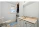 Traditional bathroom with blue accents, single vanity, and an enclosed shower/bath combo at 1503 Westwood Sw Ave, Atlanta, GA 30310