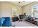 Office with a desk, plush blue couch, and lots of light from the window at 1503 Westwood Sw Ave, Atlanta, GA 30310