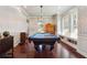 Well-lit billiards room with unique wallpaper and hardwood floors at 1503 Westwood Sw Ave, Atlanta, GA 30310