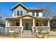 Charming two-story home featuring a large front porch and a vibrant turquoise front door at 1503 Westwood Sw Ave, Atlanta, GA 30310