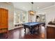 Bright game room with pool table, hardwood floors, and custom lighting fixture at 1503 Westwood Sw Ave, Atlanta, GA 30310
