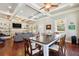 Open-concept living and dining room featuring hardwood floors, coffered ceiling, and a built-in bookcase at 1503 Westwood Sw Ave, Atlanta, GA 30310
