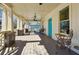 Inviting covered porch with wooden floors, ornate seating, and a bright turquoise door at 1503 Westwood Sw Ave, Atlanta, GA 30310