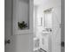 Charming bathroom with a pedestal sink, white vanity, and built-in shelving at 1882 Rosewood Rd, Decatur, GA 30032