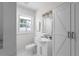 A bright bathroom features white cabinets, marble counter tops, and modern fixtures at 1882 Rosewood Rd, Decatur, GA 30032