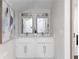 Bright bathroom featuring a double sink vanity with sleek white cabinets and modern fixtures at 1882 Rosewood Rd, Decatur, GA 30032