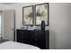 A bedroom features a dark wood dresser with modern artwork and accents at 1882 Rosewood Rd, Decatur, GA 30032