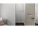 A view of a closet with dark laminate flooring, white walls and wire shelving with a comfortable chair nearby at 1882 Rosewood Rd, Decatur, GA 30032